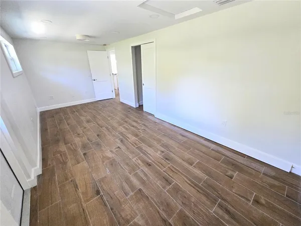 an empty room with wooden floor