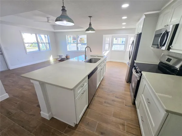 a kitchen with sink and mirror