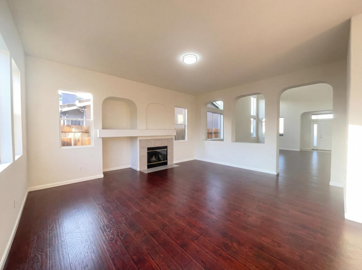 8137 Wyndwillow Way Elk Grove, CA 95758 - Photo 13 of 41 a view of an empty room with wooden floor and a fireplace