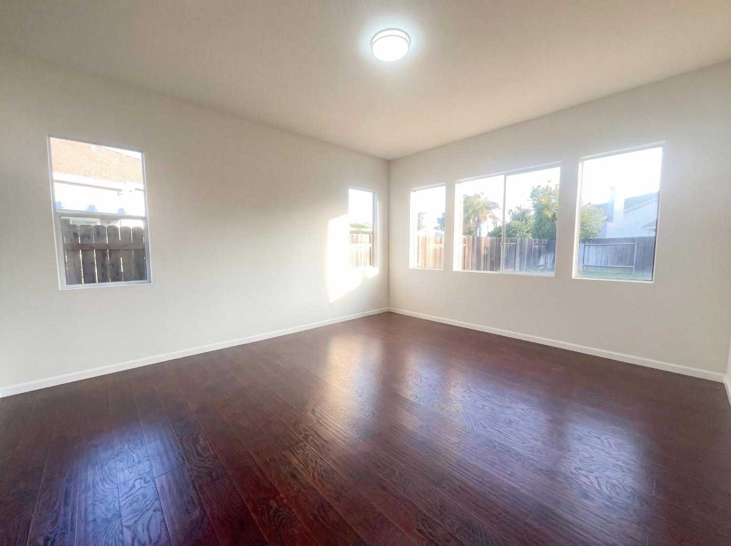 8137 Wyndwillow Way Elk Grove, CA 95758 - Photo 23 of 41 an empty room with wooden floor and windows