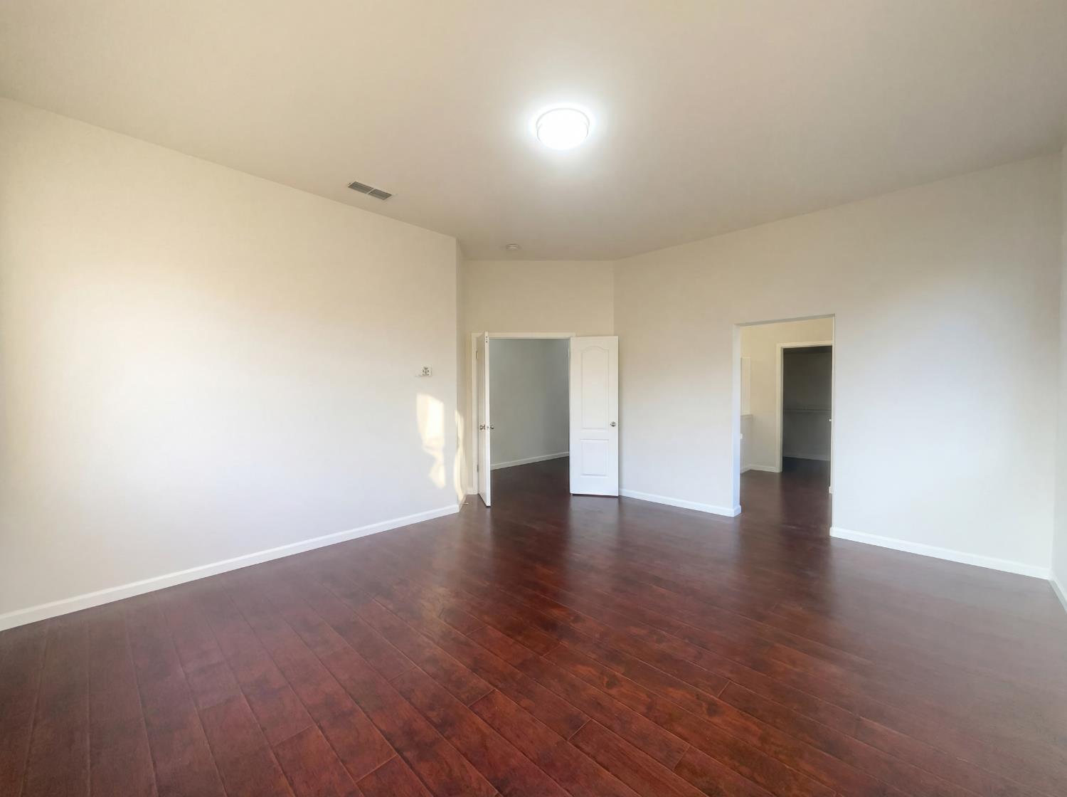 8137 Wyndwillow Way Elk Grove, CA 95758 - Photo 24 of 41 a view of an empty room with wooden floor and closet