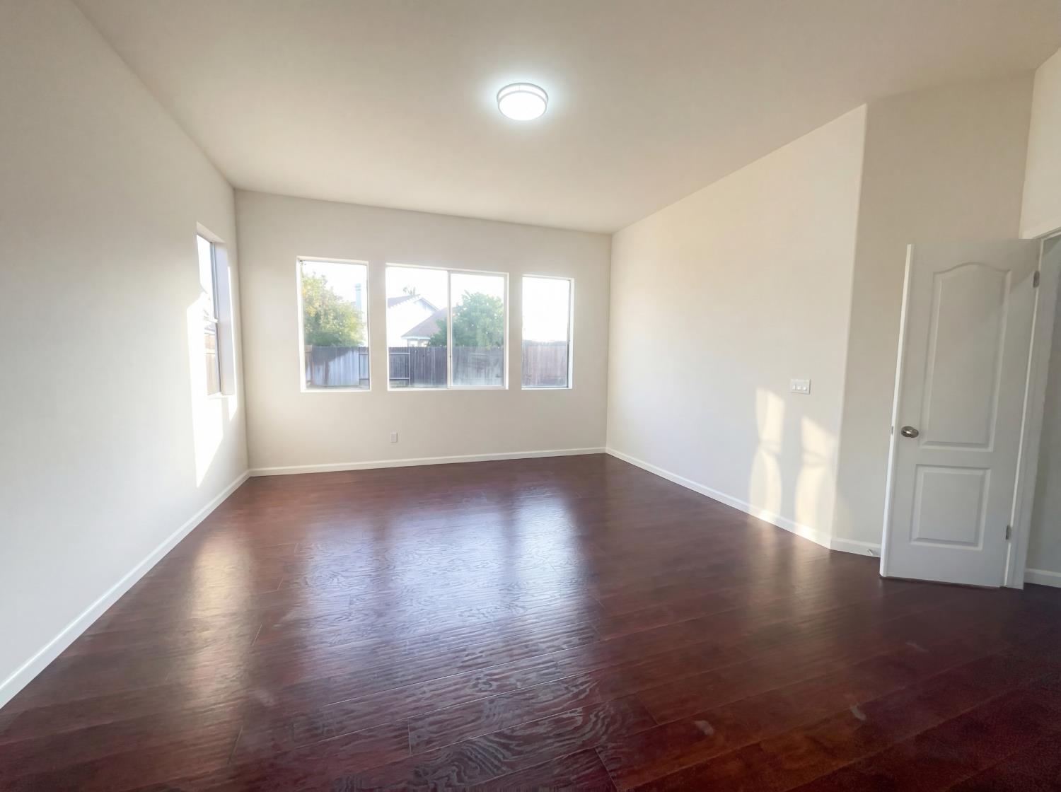 8137 Wyndwillow Way Elk Grove, CA 95758 - Photo 29 of 41 an empty room with wooden floor and windows