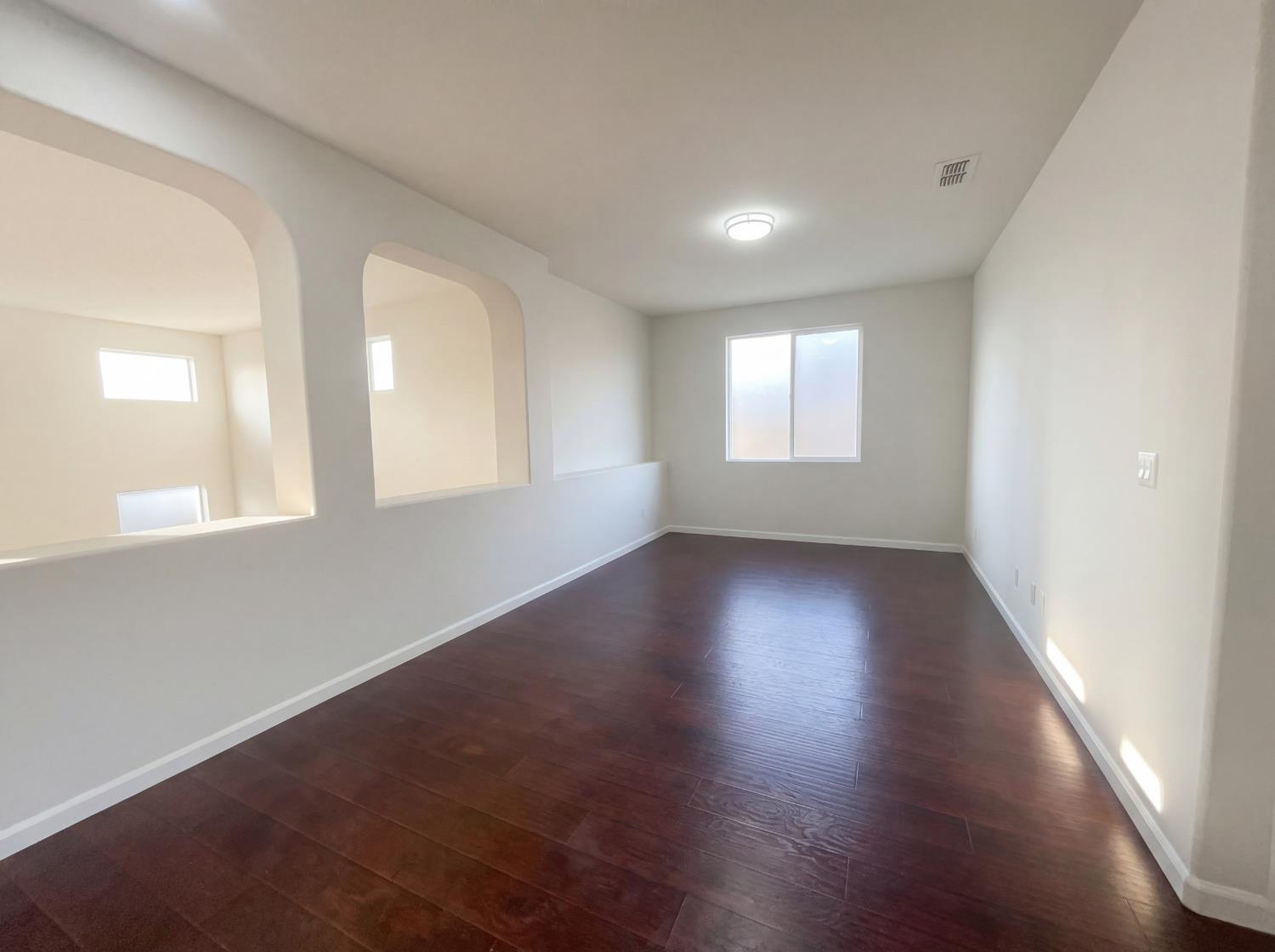 8137 Wyndwillow Way Elk Grove, CA 95758 - Photo 30 of 41 an empty room with wooden floor and windows
