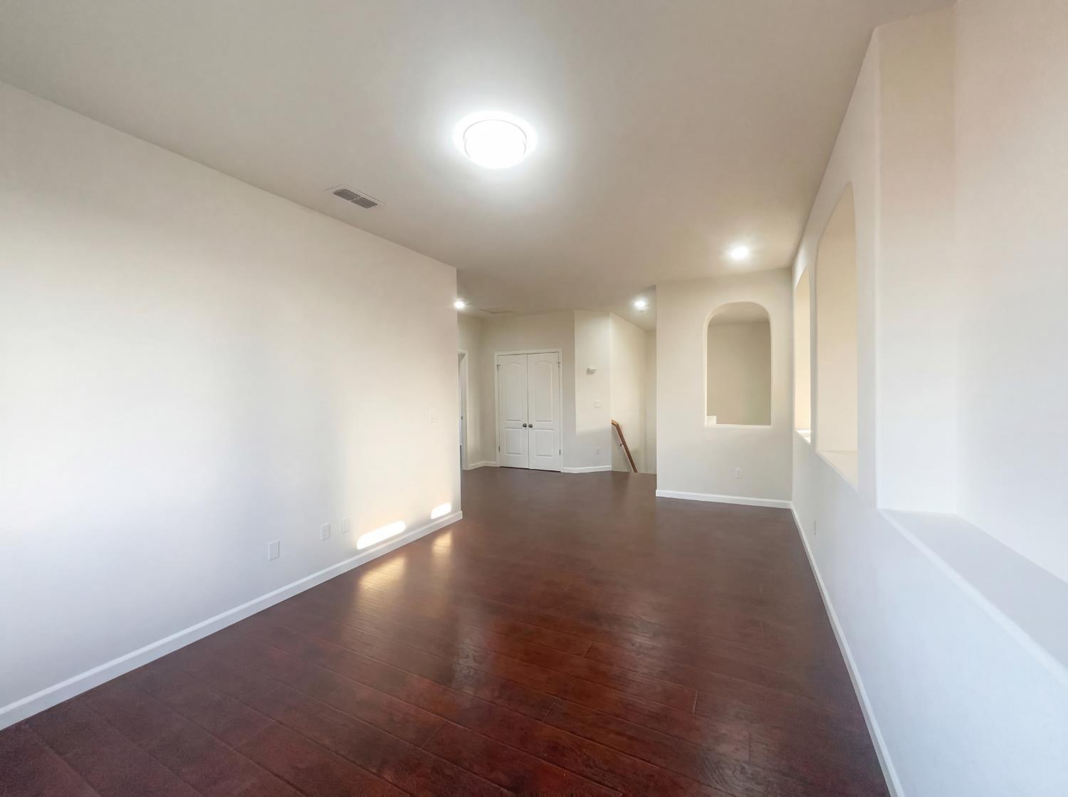 8137 Wyndwillow Way Elk Grove, CA 95758 - Photo 31 of 41 an empty room with wooden floor and windows