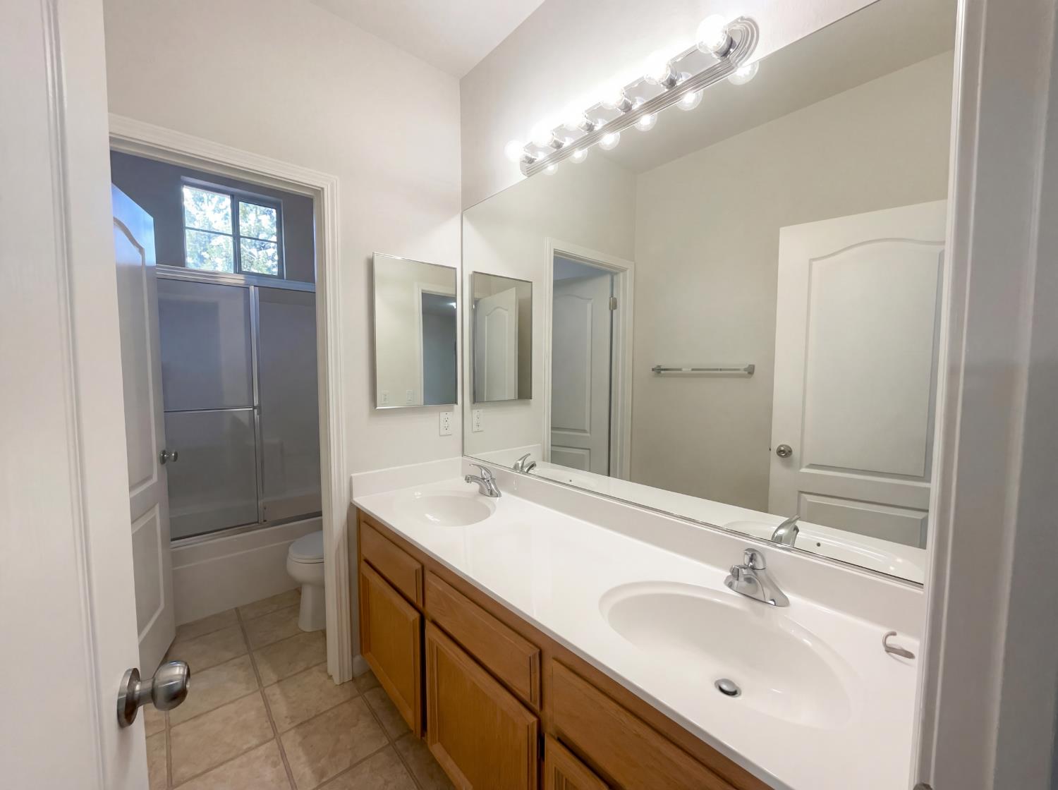 8137 Wyndwillow Way Elk Grove, CA 95758 - Photo 34 of 41 a bathroom with a double vanity sink mirror and shower