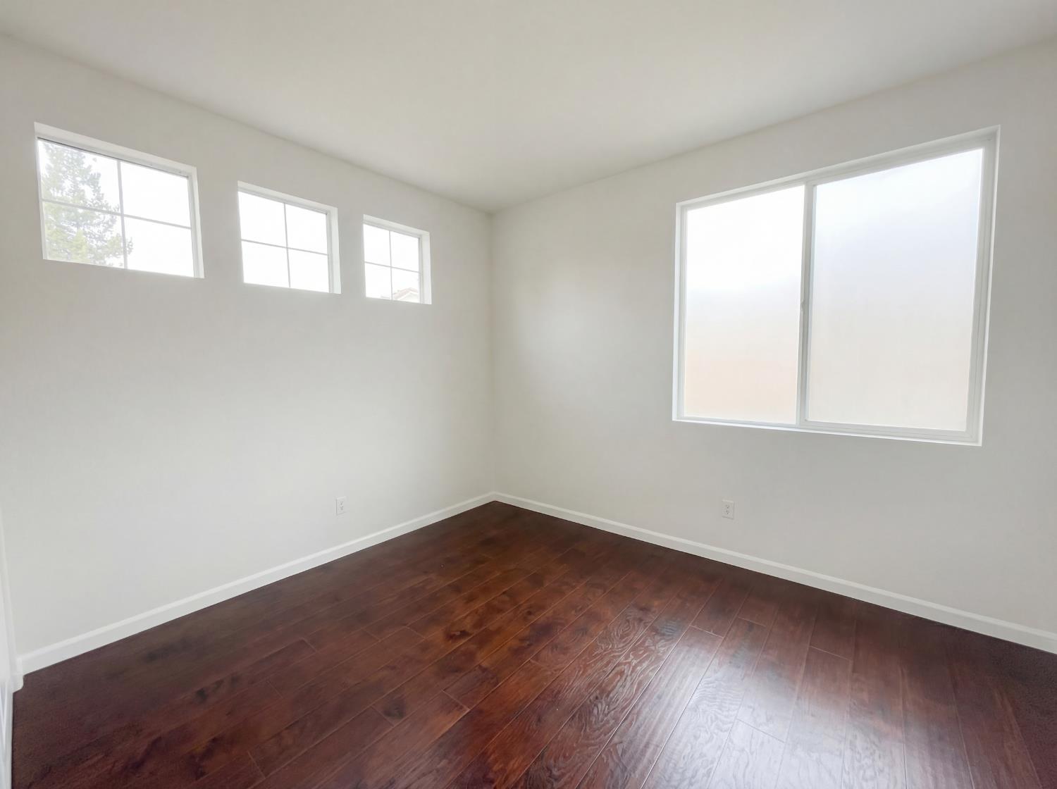 8137 Wyndwillow Way Elk Grove, CA 95758 - Photo 37 of 41 an empty room with wooden floor and windows