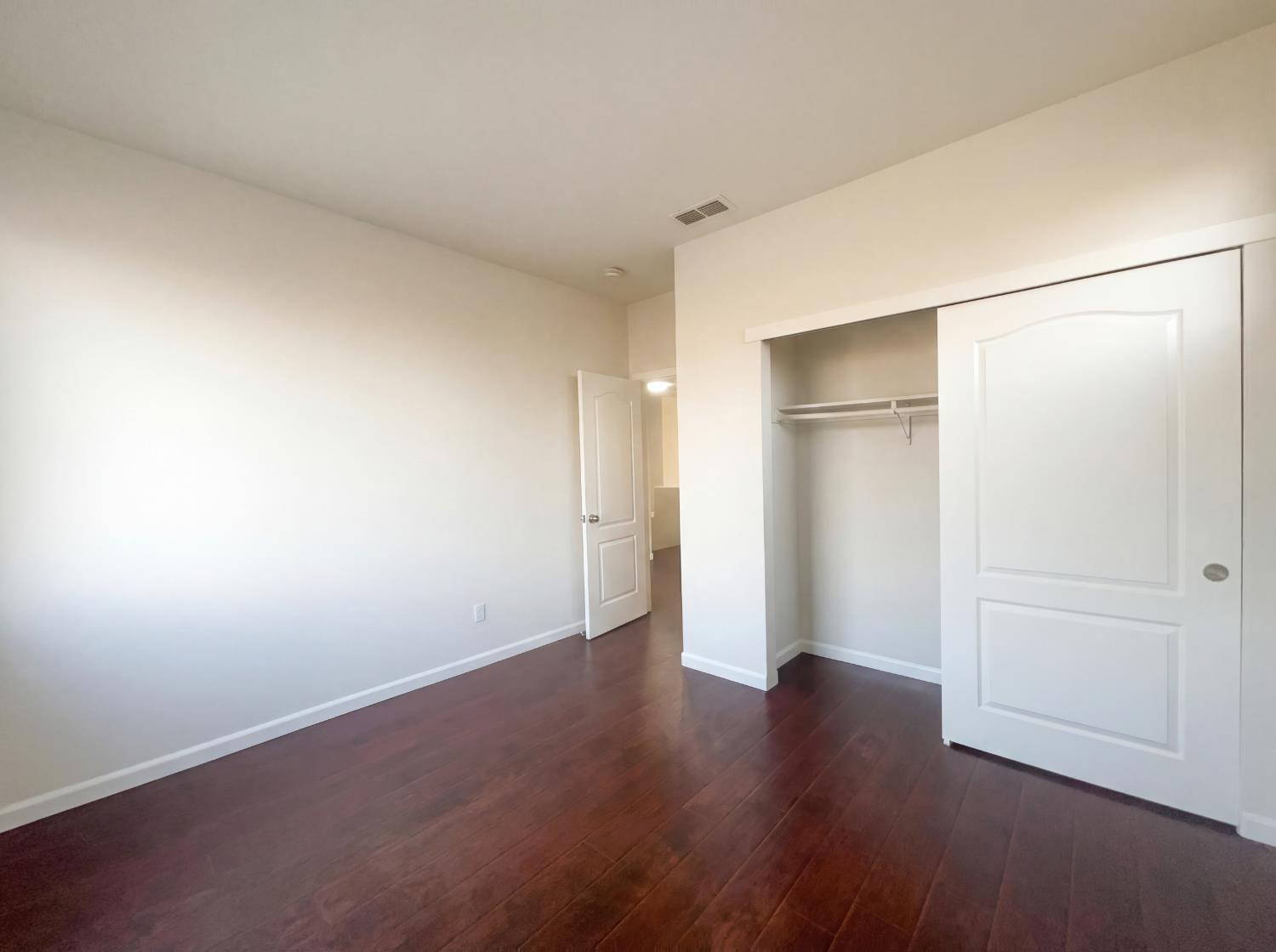 8137 Wyndwillow Way Elk Grove, CA 95758 - Photo 38 of 41 an empty room with wooden floor and closet area