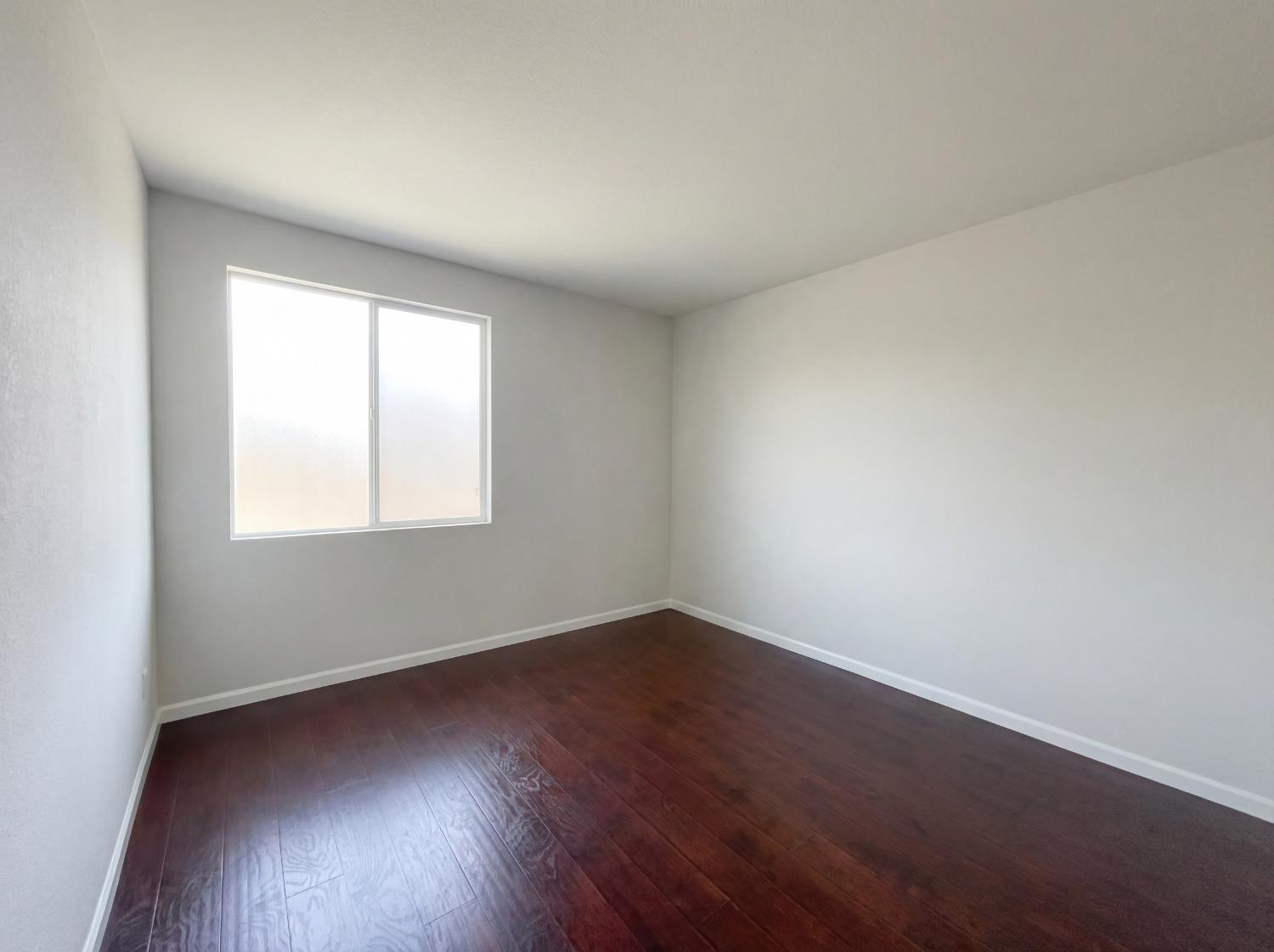 8137 Wyndwillow Way Elk Grove, CA 95758 - Photo 39 of 41 an empty room with wooden floor and windows