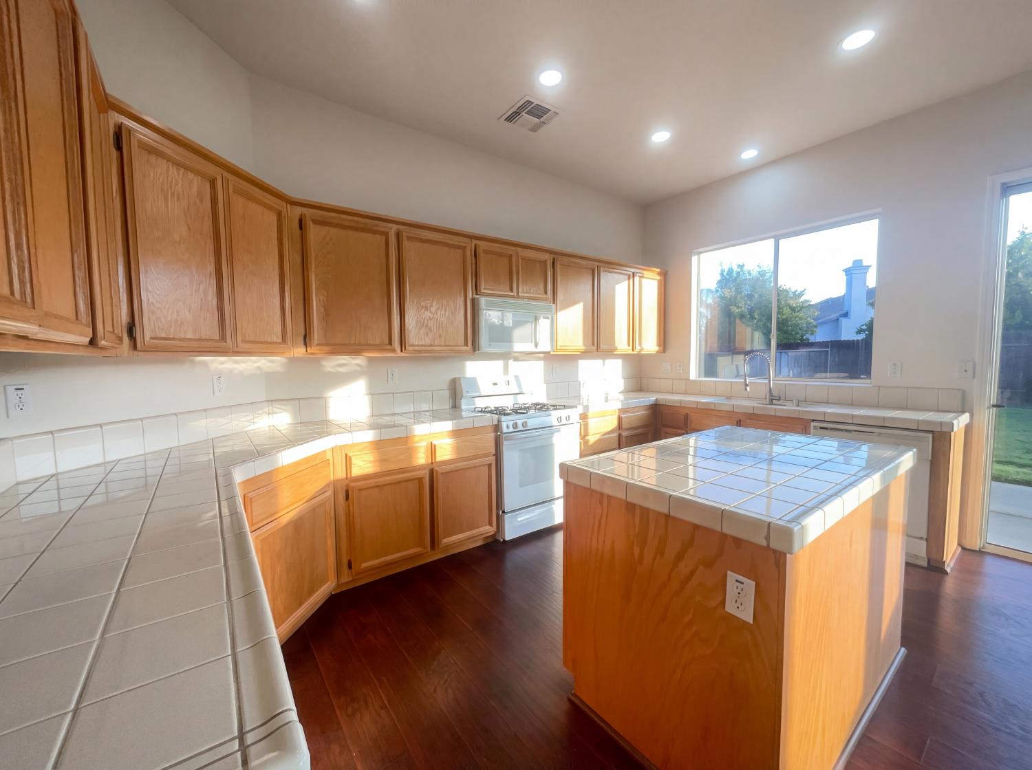 8137 Wyndwillow Way Elk Grove, CA 95758 - Photo 6 of 41 a kitchen with kitchen island granite countertop wooden cabinets a sink and a stove