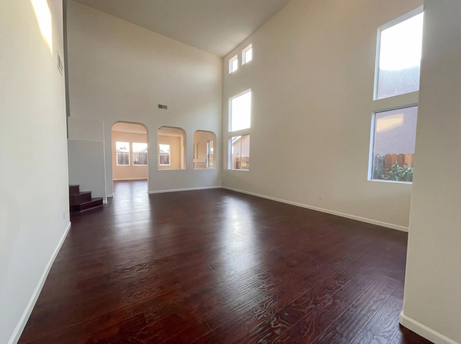 8137 Wyndwillow Way Elk Grove, CA 95758 - Photo 10 of 41 an empty room with wooden floor and windows