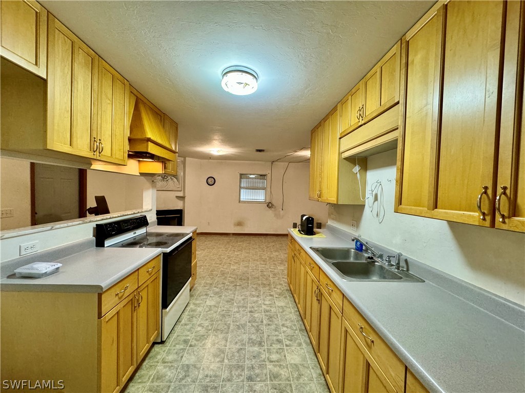 720 E Road LaBelle, FL 33935 - Photo 19 of 40 a kitchen with stainless steel appliances granite countertop a sink stove and refrigerator