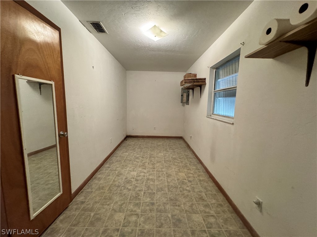 720 E Road LaBelle, FL 33935 - Photo 21 of 40 en empty room with wooden floor and windows