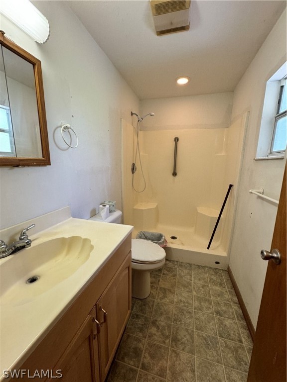 720 E Road LaBelle, FL 33935 - Photo 22 of 40 a bathroom with a sink a toilet a mirror and vanity