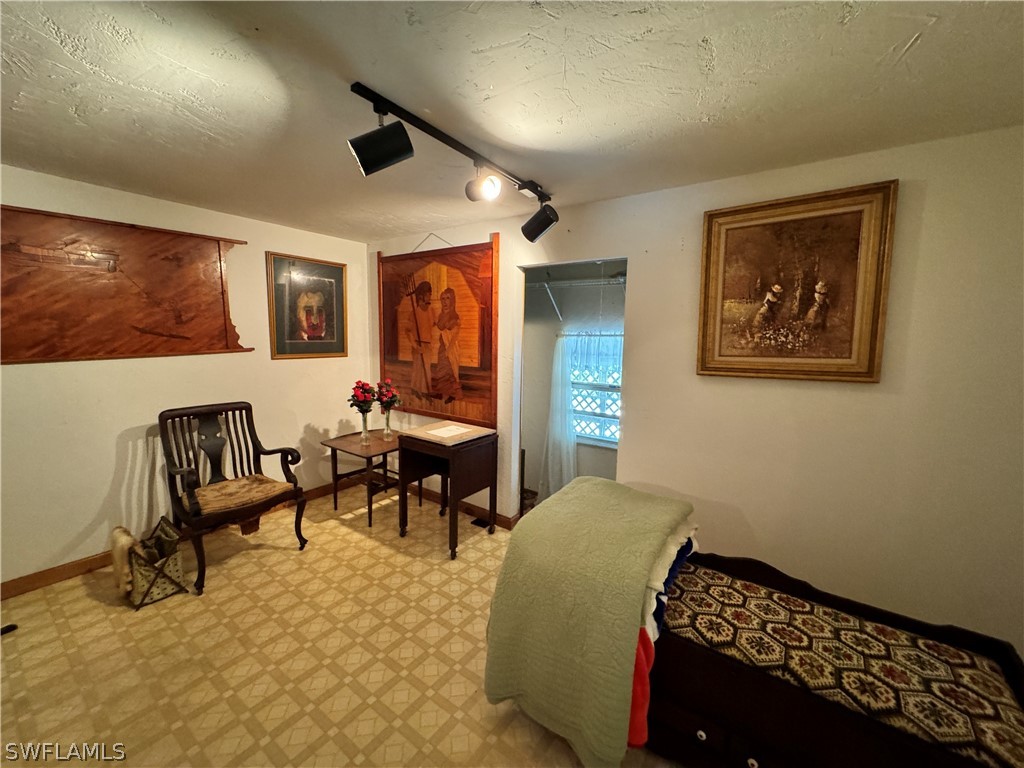 720 E Road LaBelle, FL 33935 - Photo 32 of 40 a bedroom with furniture and a rug