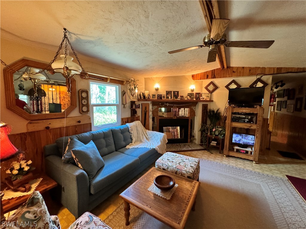 720 E Road LaBelle, FL 33935 - Photo 35 of 40 a living room with furniture a flat screen tv and gym equipment