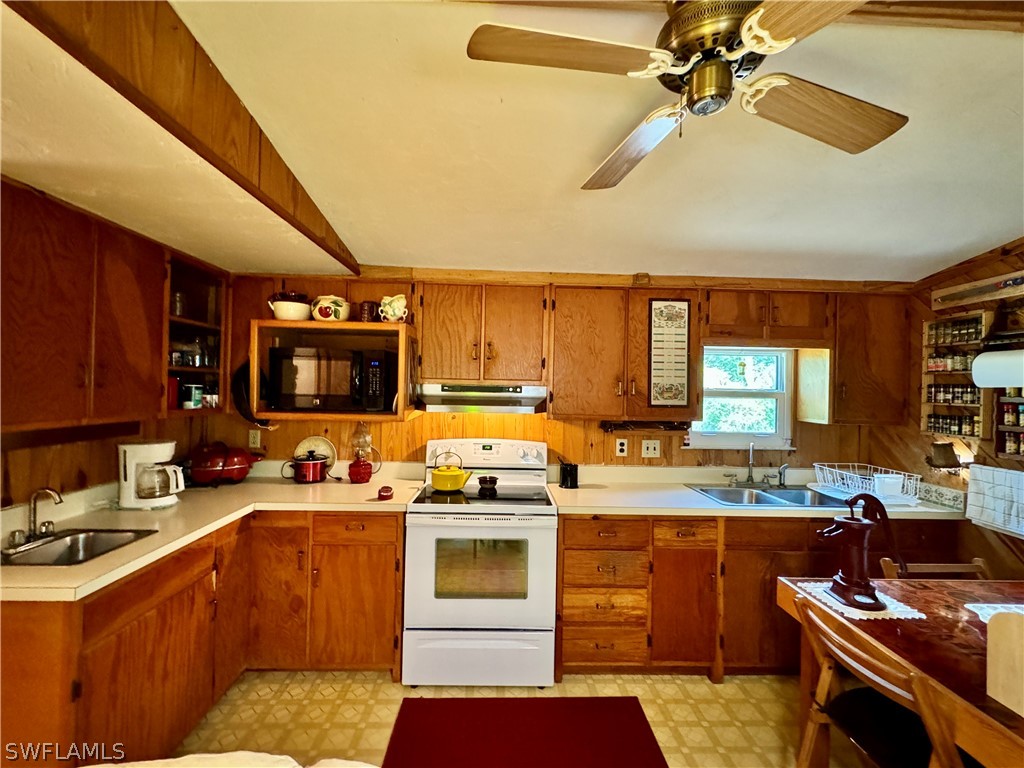 720 E Road LaBelle, FL 33935 - Photo 36 of 40 a kitchen with a sink appliances and cabinets
