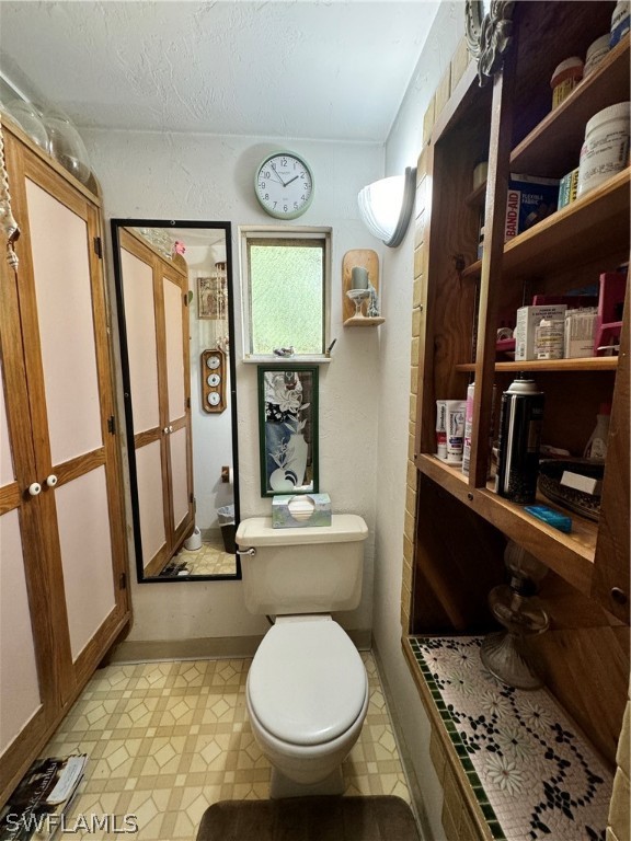 720 E Road LaBelle, FL 33935 - Photo 40 of 40 a bathroom with a toilet a sink and a mirror
