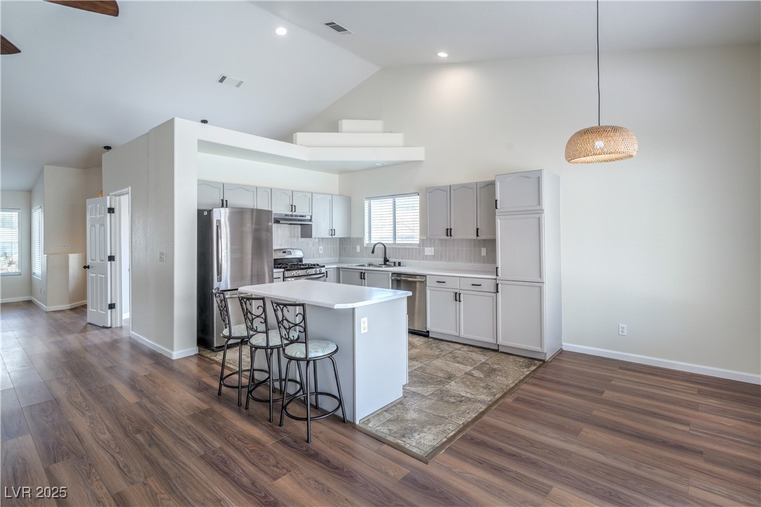 818 Coastal Beach Road Henderson, NV 89002 - Photo 15 of 39 Kitchen featuring backsplash, appliances with stai