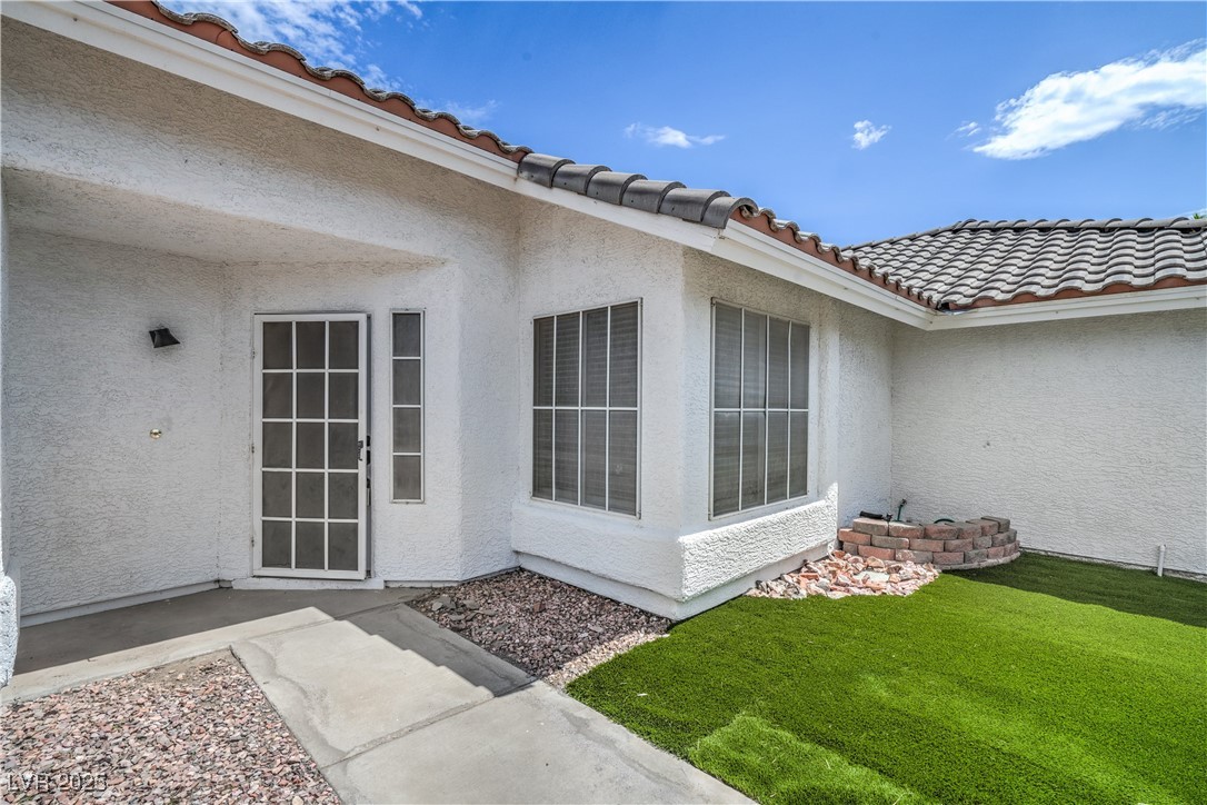 818 Coastal Beach Road Henderson, NV 89002 - Photo 4 of 39 Entrance to property with a tiled roof, stucco sid