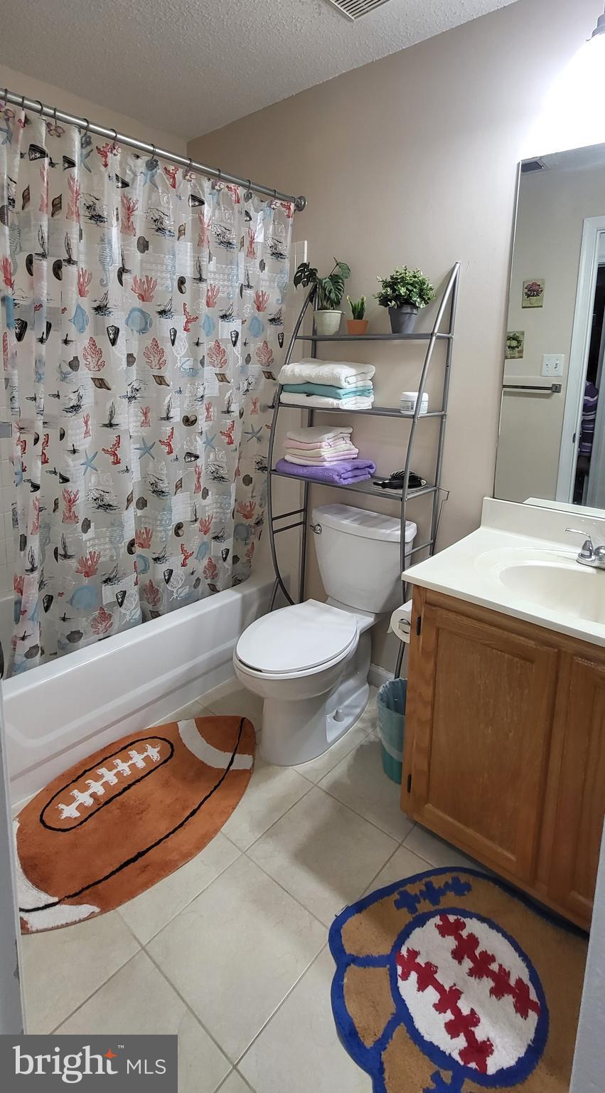 2703 Leaf Drop Court, Unit 817 Silver Spring, MD 20906 - Photo 11 of 16 a bathroom with a toilet and a mirror