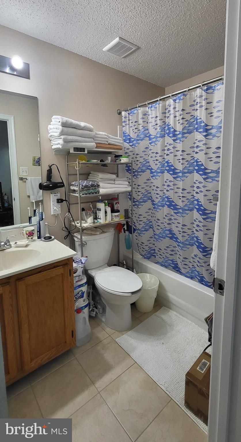2703 Leaf Drop Court, Unit 817 Silver Spring, MD 20906 - Photo 12 of 16 a bathroom with a sink toilet and shower