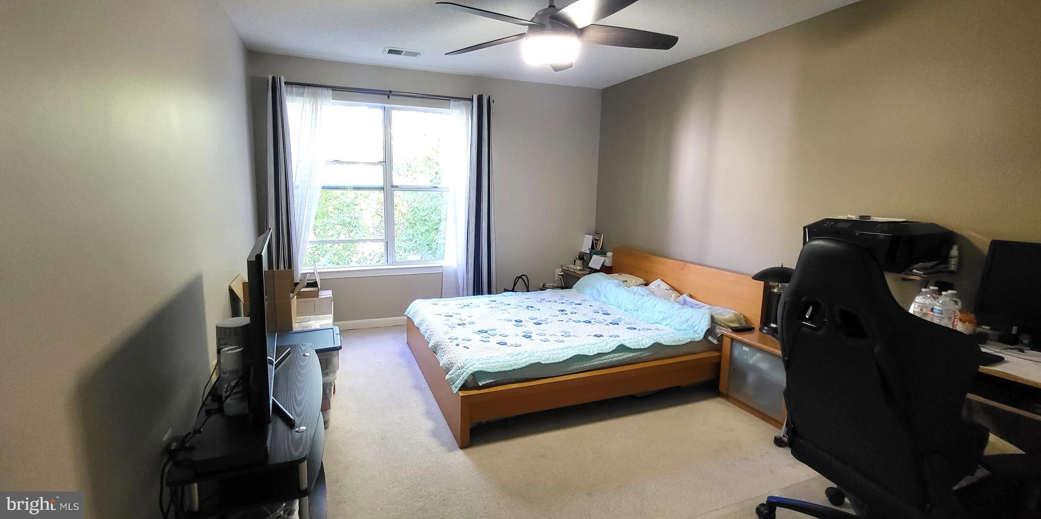 2703 Leaf Drop Court, Unit 817 Silver Spring, MD 20906 - Photo 13 of 16 a bedroom with a bed and a window