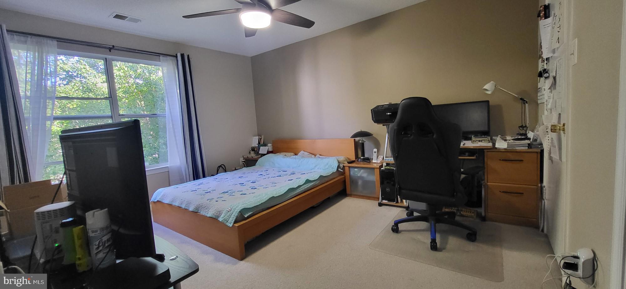 2703 Leaf Drop Court, Unit 817 Silver Spring, MD 20906 - Photo 14 of 16 a bedroom with a bed and a window