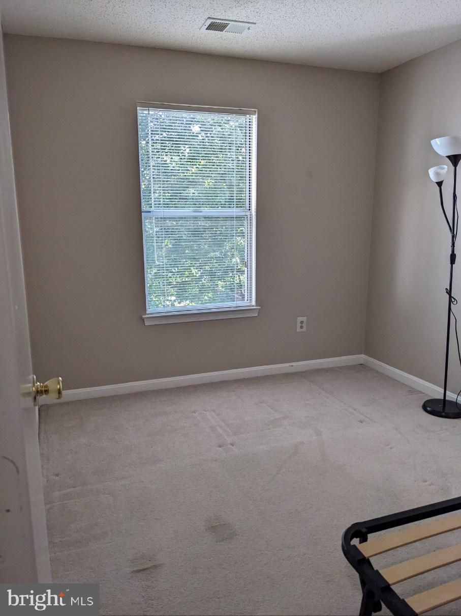 2703 Leaf Drop Court, Unit 817 Silver Spring, MD 20906 - Photo 9 of 16 an empty room with a window