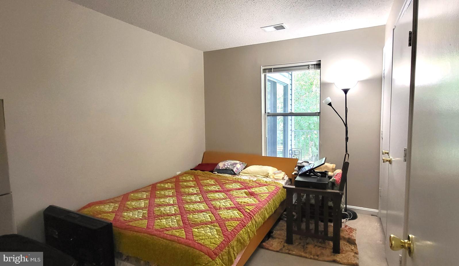 2703 Leaf Drop Court, Unit 817 Silver Spring, MD 20906 - Photo 10 of 16 a bedroom with a bed and a window