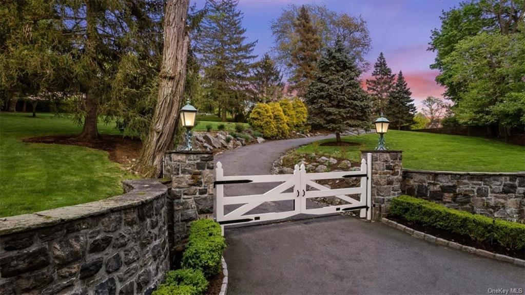Gated entry starts the journey to the front door up a long winding drive.