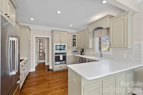a kitchen with cabinets appliances and a window