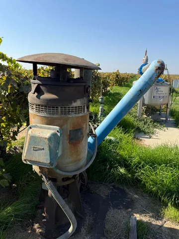 a view of a large building with mountains in the background