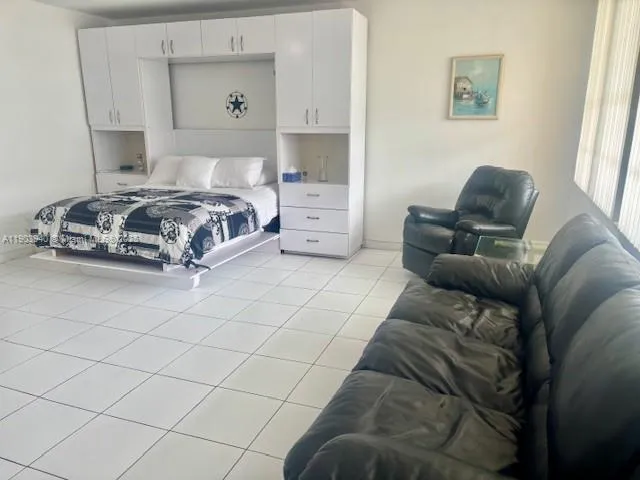 a spacious bedroom with a bed and a couch