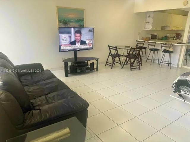 a living room with furniture and kitchen view