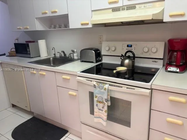 a close view of laundry room with furniture and lamp