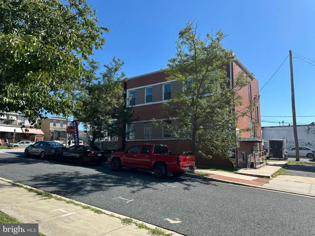 a view of a cars parked on the side of a street