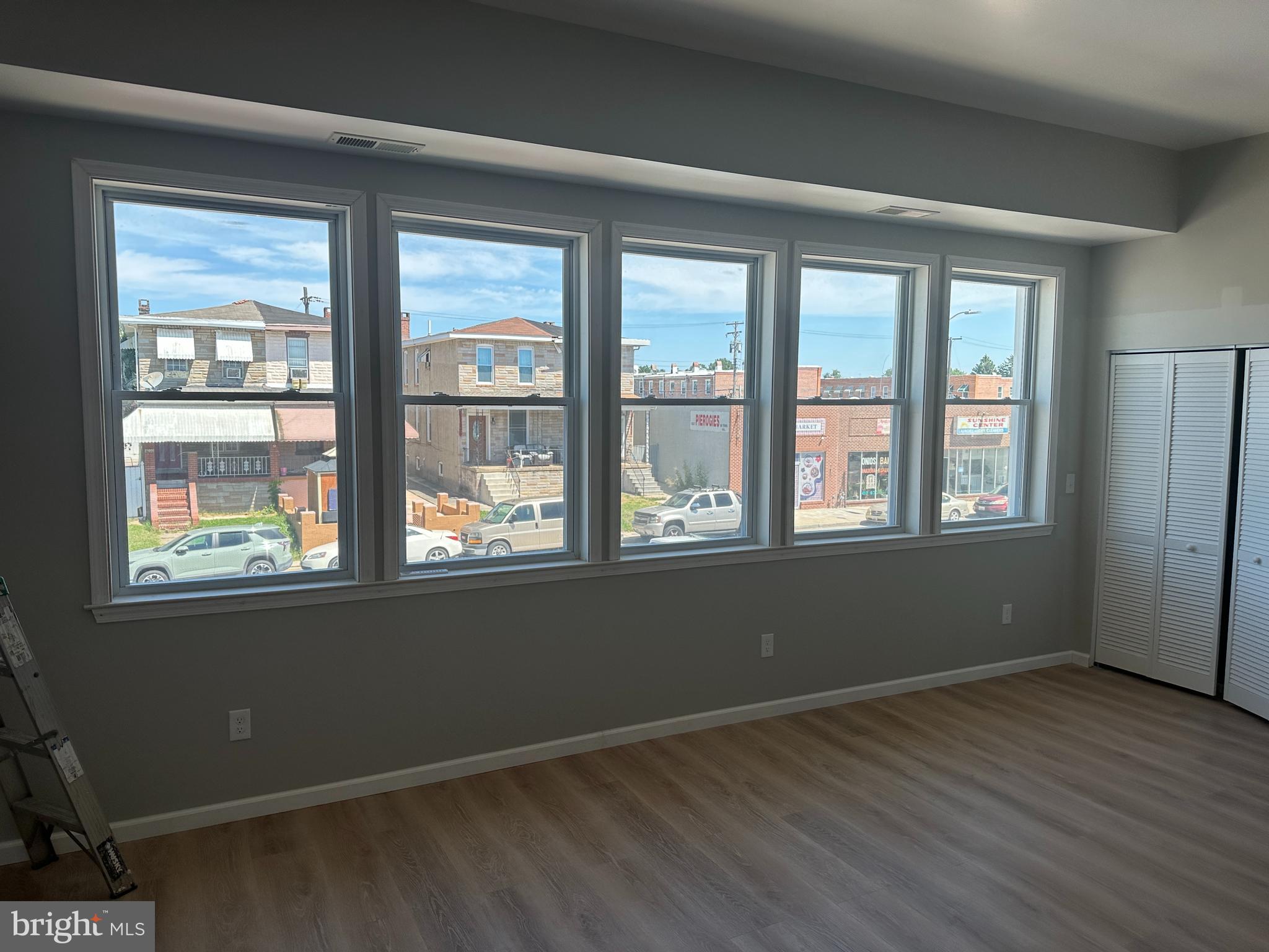 6201 Eastern Avenue Baltimore, MD 21224 - Photo 2 of 7 a view of an empty room with wooden floor and a window
