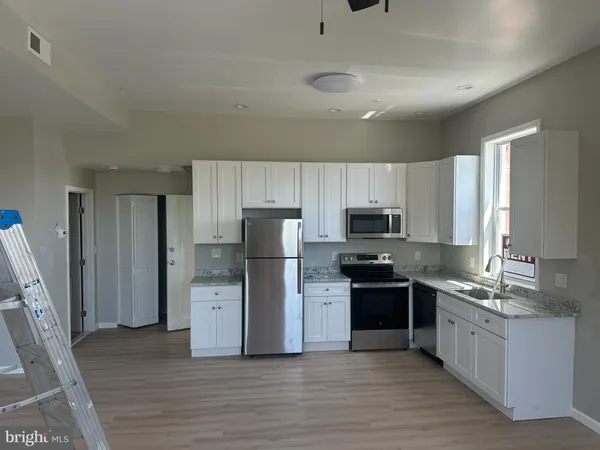 a kitchen with a refrigerator and a sink