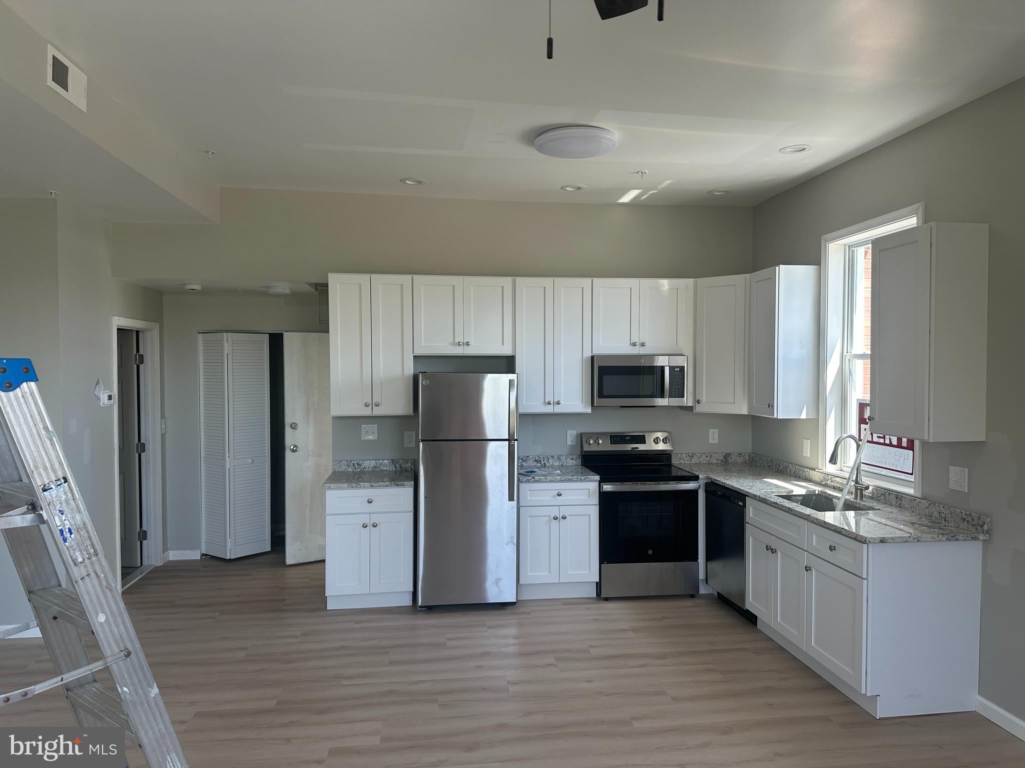 6201 Eastern Avenue Baltimore, MD 21224 - Photo 3 of 7 a kitchen with a refrigerator and a sink