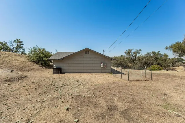a big house with a mountain in the background