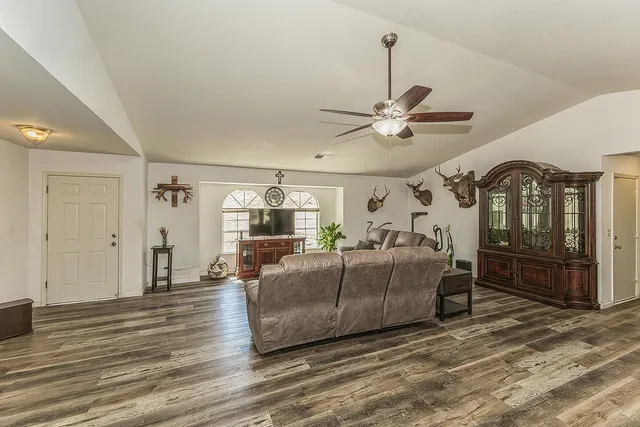 a living room with furniture and a wooden floor