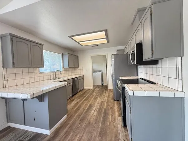 a kitchen with a sink stove and refrigerator