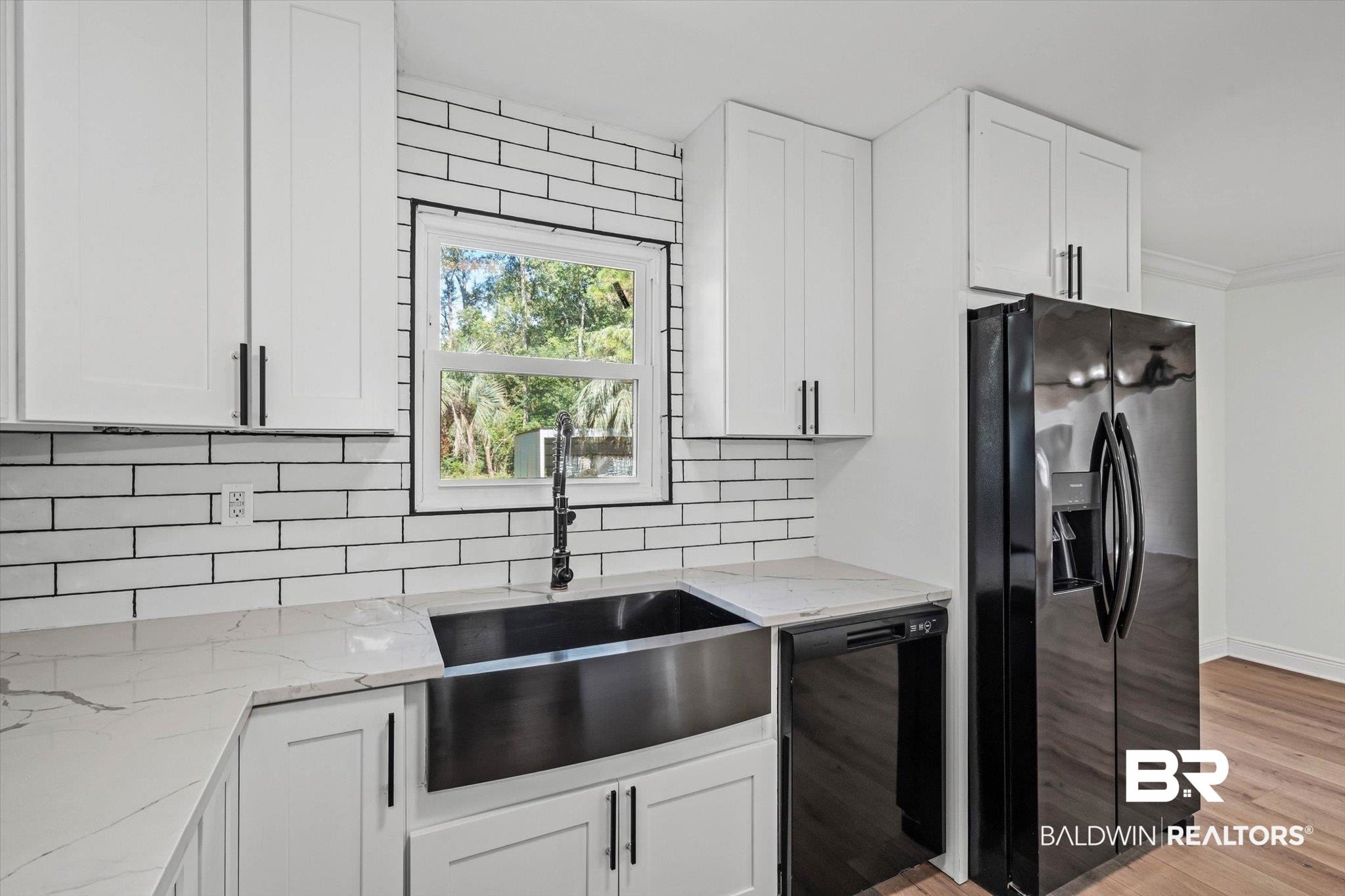 4156 Furman Drive Mobile, AL 36619 - Photo 8 of 24 Kitchen featuring black appliances, light stone countertops, white cabinetry, light wood-style flooring, and ornamental molding