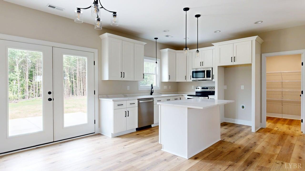 3729 Kentuck Road Ringgold, VA 24586 - Photo 13 of 42 a kitchen with white cabinets and white appliances