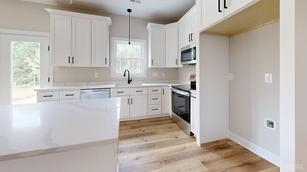 3729 Kentuck Road Ringgold, VA 24586 - Photo 14 of 42 a kitchen with stainless steel appliances granite countertop a stove a sink and a refrigerator