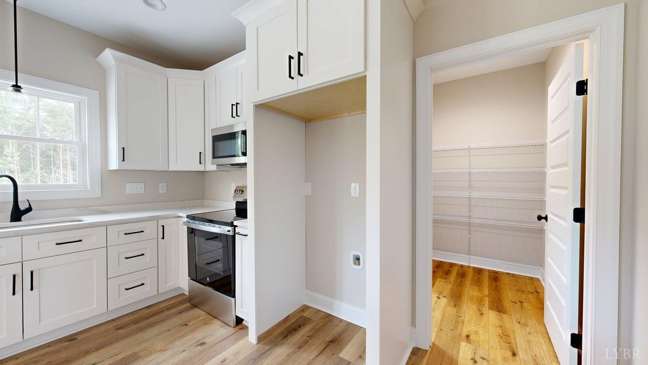 3729 Kentuck Road Ringgold, VA 24586 - Photo 15 of 42 a kitchen with a refrigerator and cabinets