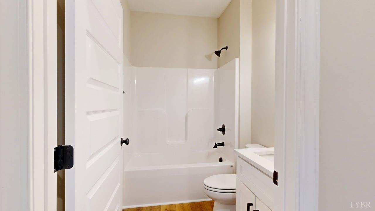 3729 Kentuck Road Ringgold, VA 24586 - Photo 19 of 42 a bathroom with a bathtub shower sink vanity and a toilet