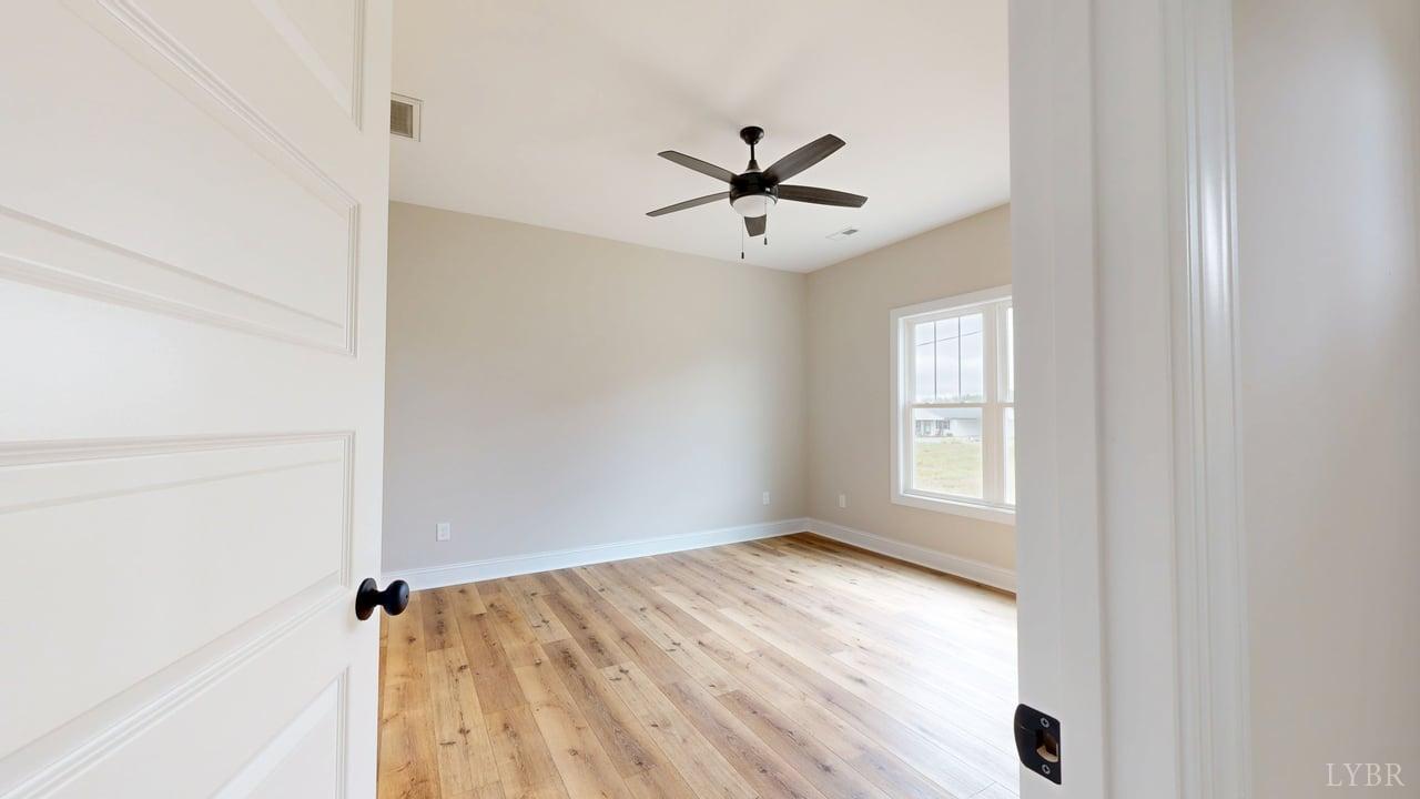3729 Kentuck Road Ringgold, VA 24586 - Photo 20 of 42 a view of empty room with wooden floor and fan