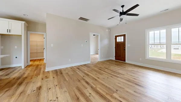 a view of empty room with wooden floor and fireplace