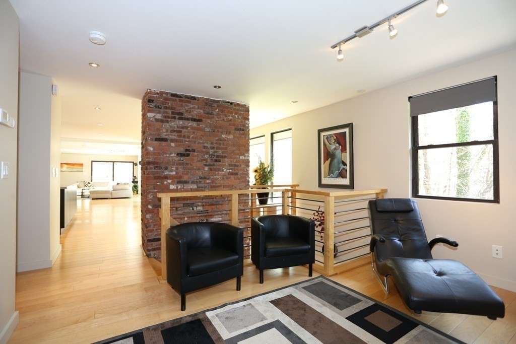 10 Country Corners Road Wayland, MA 01778 - Photo 15 of 32 a living room with furniture a flat screen tv and a fireplace
